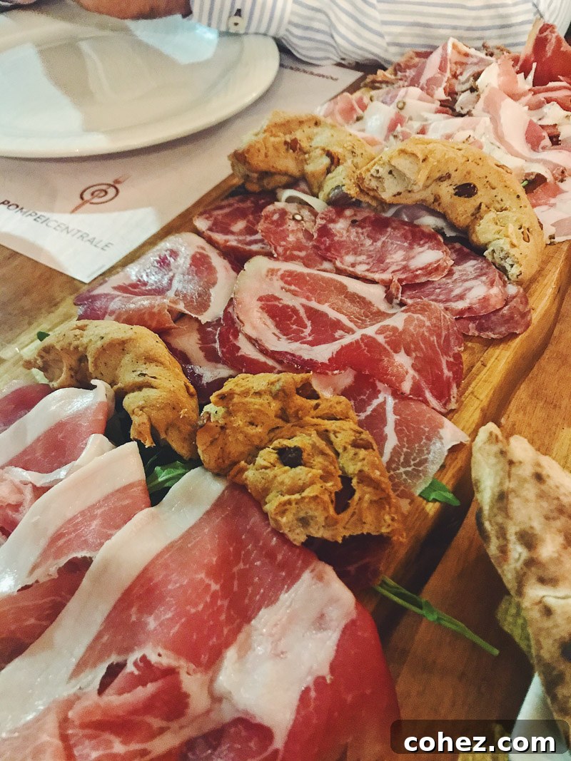 Delicious antipasti platter featuring cured meats, artisan cheeses, fresh bread, and olives, perfect for wine pairing