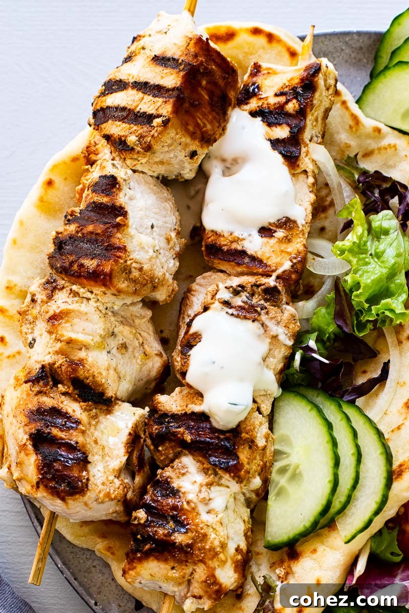 Delicious Homemade Chicken Souvlaki 4 two chicken skewers on top of flatbread drizzled with yogurt