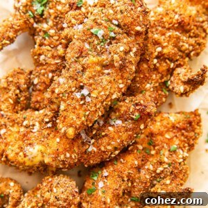Chicken fingers in crispy coating on brown paper