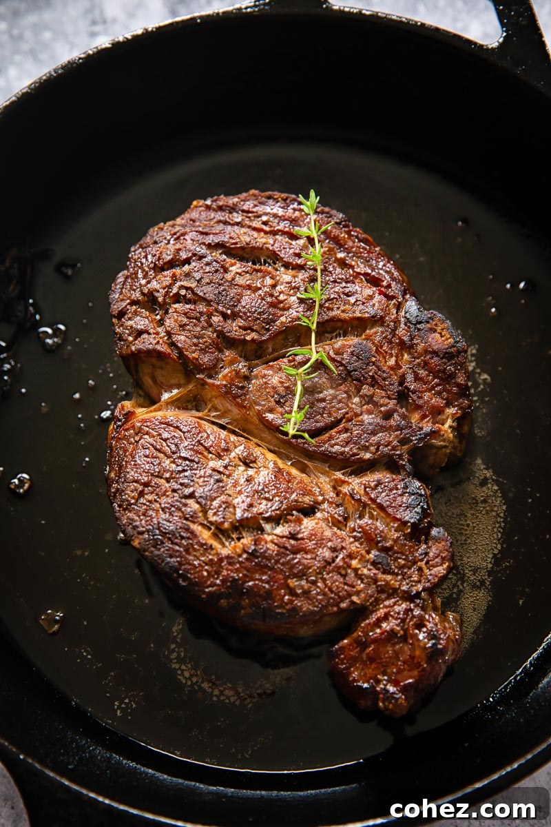 cooked ribeye on cast iron pan, perfectly seared