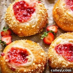 Creamy Strawberry Cheesecake Vatrushka Delights 7 Brioche buns filled with creamy cheese and vibrant strawberry jam, capturing the essence of the Strawberry Cheesecake Vatrushka Buns recipe