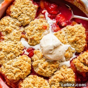 plum cobbler with a scoop of vanilla ice cream on top