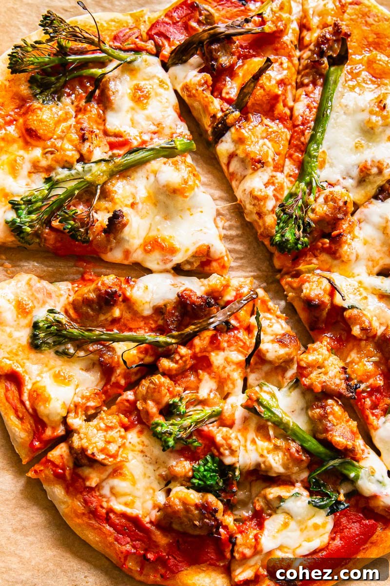 Delicious sourdough pizza topped with spicy sausage and broccoli, perfectly sliced and ready to serve.