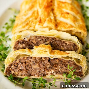 mushroom wellington on white platter with gold rim