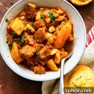 pork stew with carrots and butternut squash in bowl, cornbread muffins