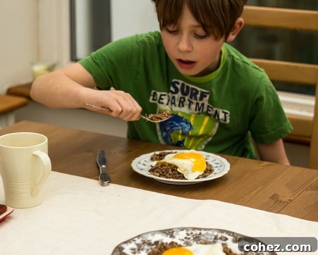 Side shot of boy eating buckwheat