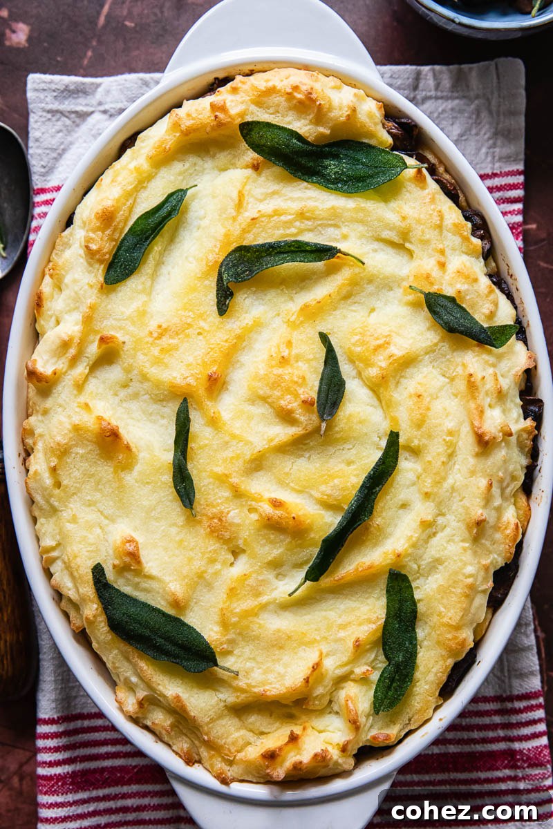 Mashed potato casserole topped with fried sage leaves, a perfect holiday side dish