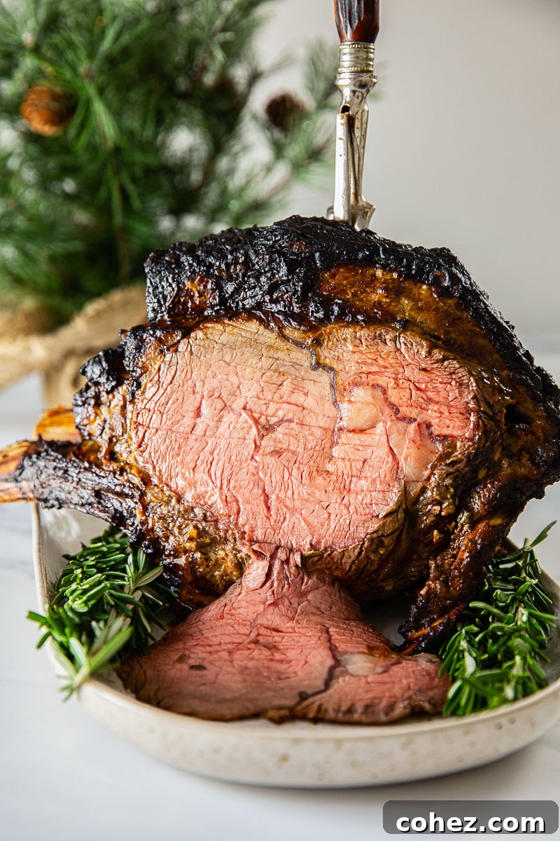 A perfectly roasted prime rib standing proudly on a serving platter, adorned with fresh rosemary, with a warmly lit Christmas tree creating a festive ambiance in the background.