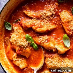 chicken in tomato sauce topped with fresh basil and breadcrumbs