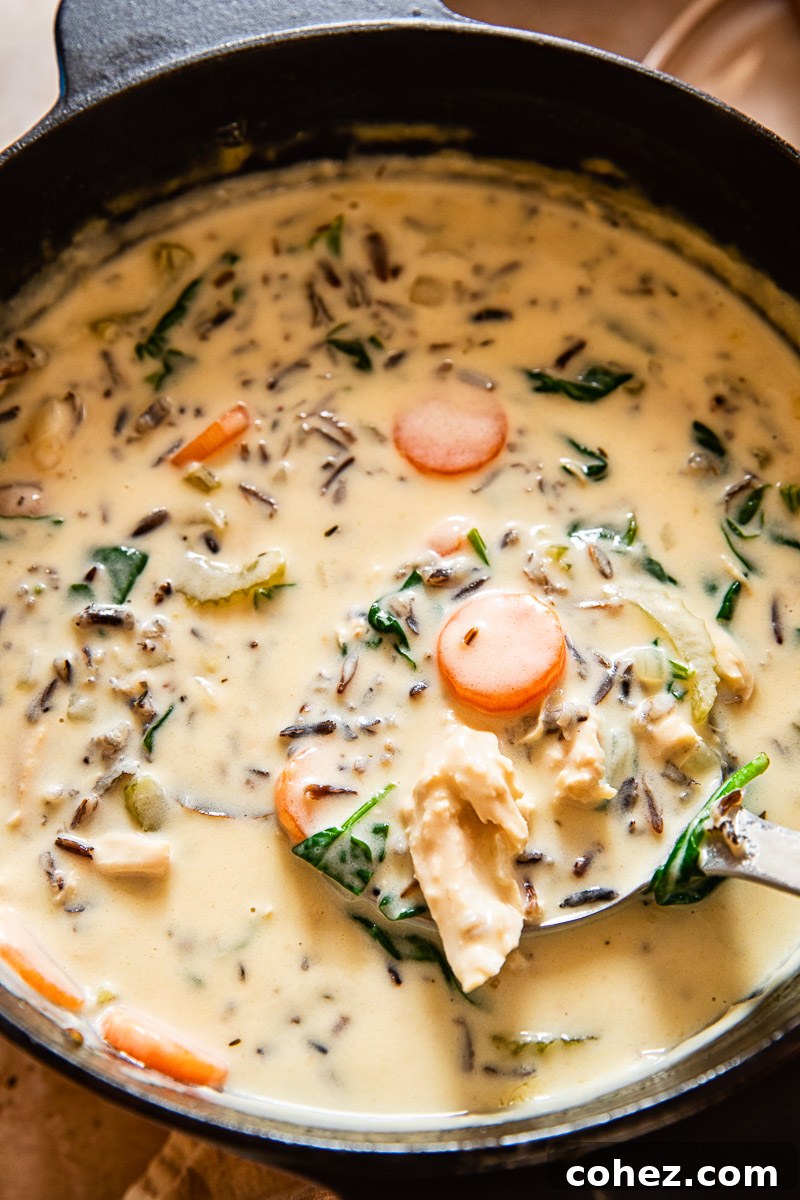 Golden Chicken Wild Rice Velvety Bliss 3 creamy chicken wild rice soup simmering in a large pot on the stovetop