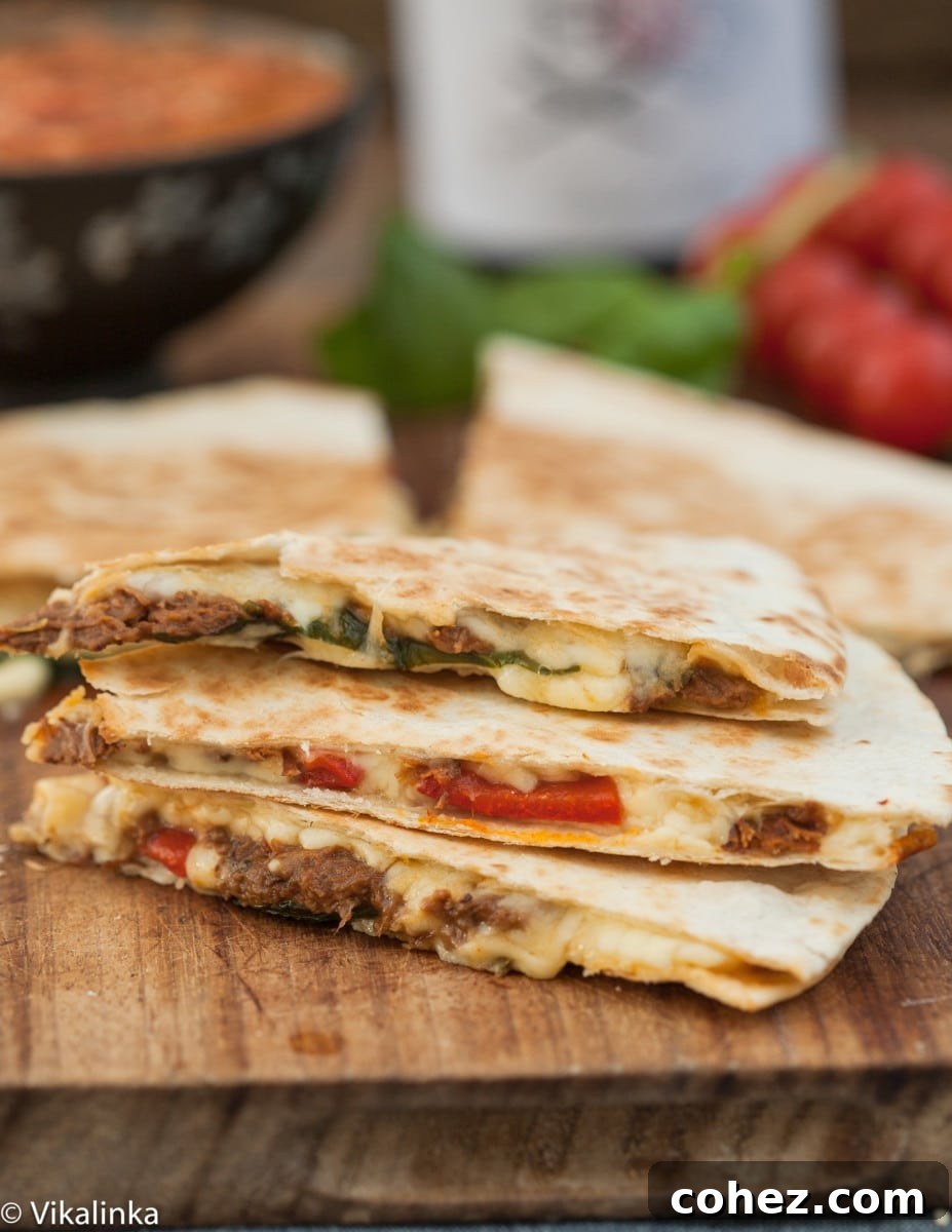 Zesty Italian Beef and Sweet Roasted Red Pepper Quesadilla 4 Stacked cut quesadillas showcasing the rich beef, cheese, and roasted pepper filling, ready to be served.