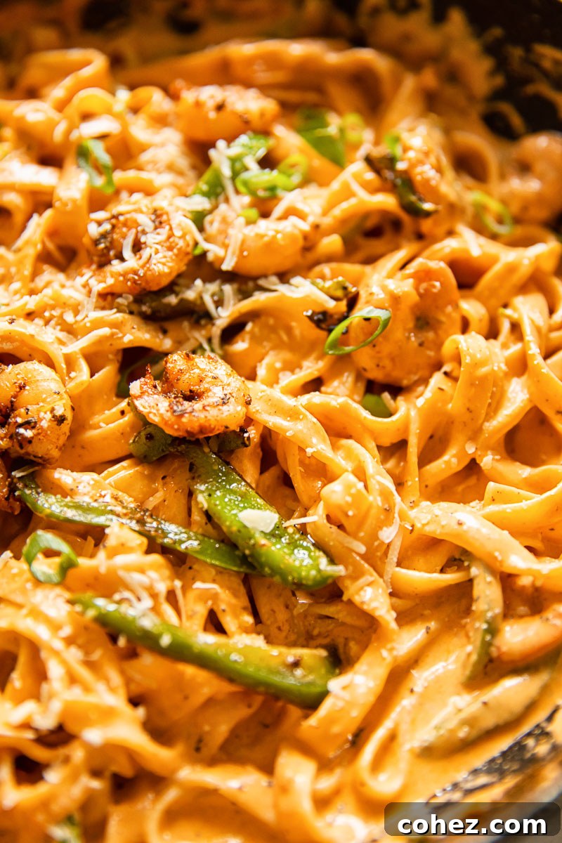 creamy shrimp pasta with green onions closeup
