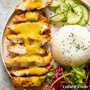 Crispy Air Fryer Chicken Katsu Curry 7 chicken katsu with curry poured over, rice, sliced cucumber