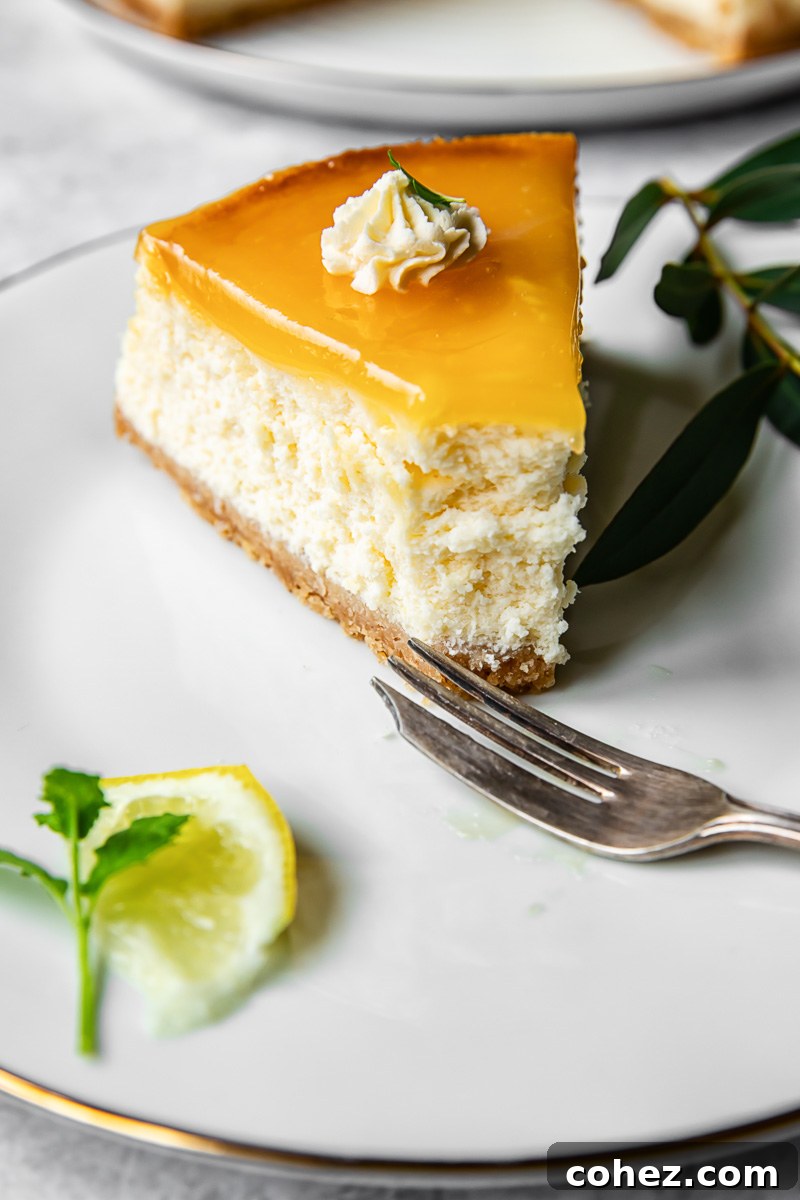 A perfectly sliced lemon cheesecake revealing its creamy, smooth interior, resting on a white plate ready to be enjoyed.