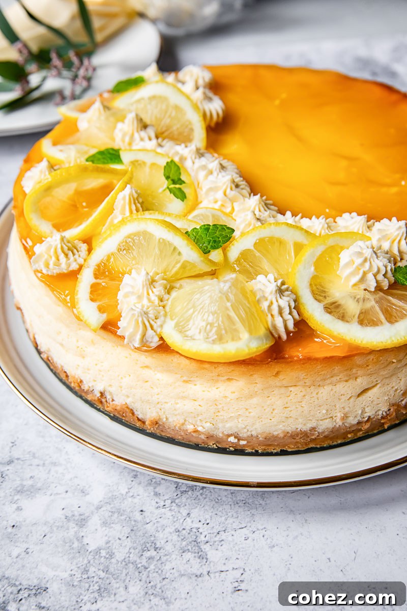 Side view of the elegant lemon curd cheesecake, showcasing its height and layers before being sliced.