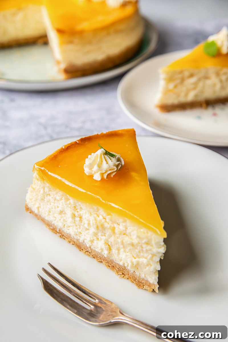 A beautifully presented slice of lemon cheesecake on a plate, garnished with a sprig of mint, highlighting its delicate texture.