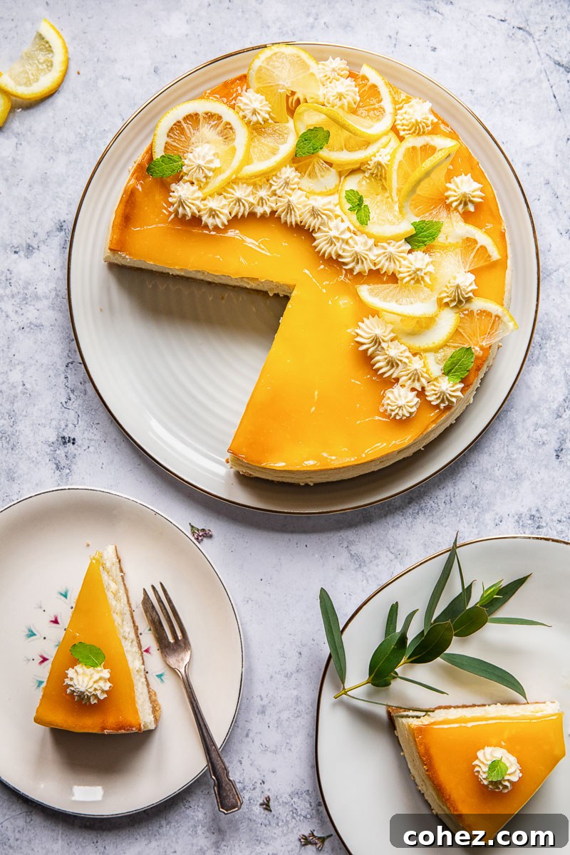 Top-down view of a freshly baked lemon cheesecake with two slices already cut and placed on plates, ready to be enjoyed.