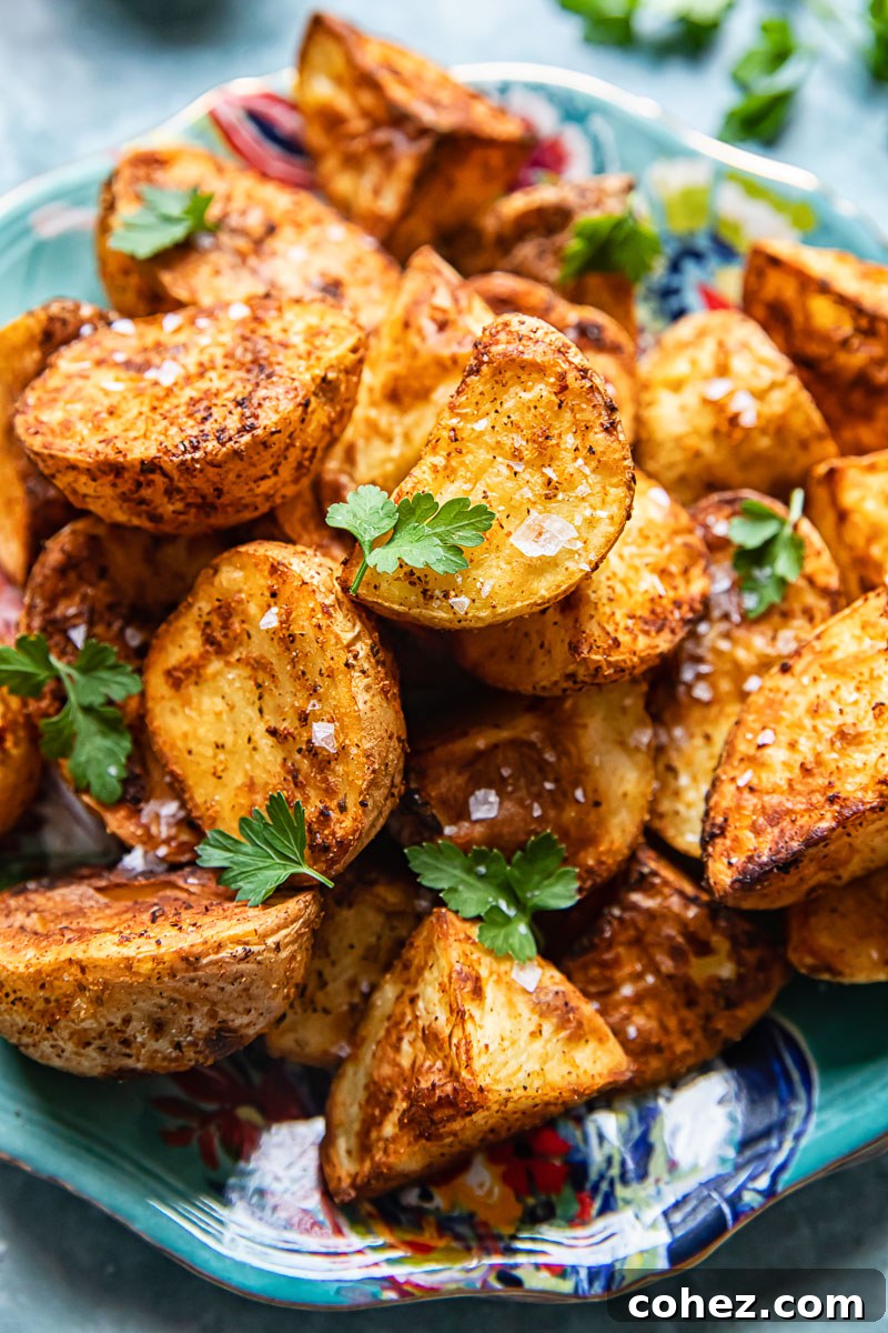 Golden Air-Fried Spuds 2 top down view of roast potatoes sprinkled with flaky salt and parsley
