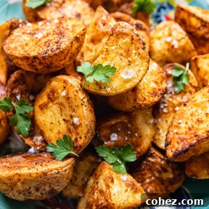 top down view of roast potatoes sprinkled with flaky salt and parsley