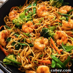 top down view of shrimp with stir fried noodles and vegetables