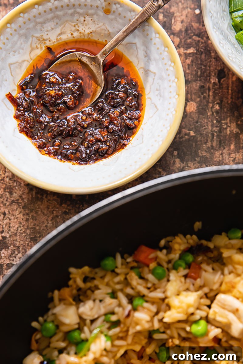 Ultimate Wok-Fired Chicken Rice 3 Chinese chilli oil and fried rice in a pan