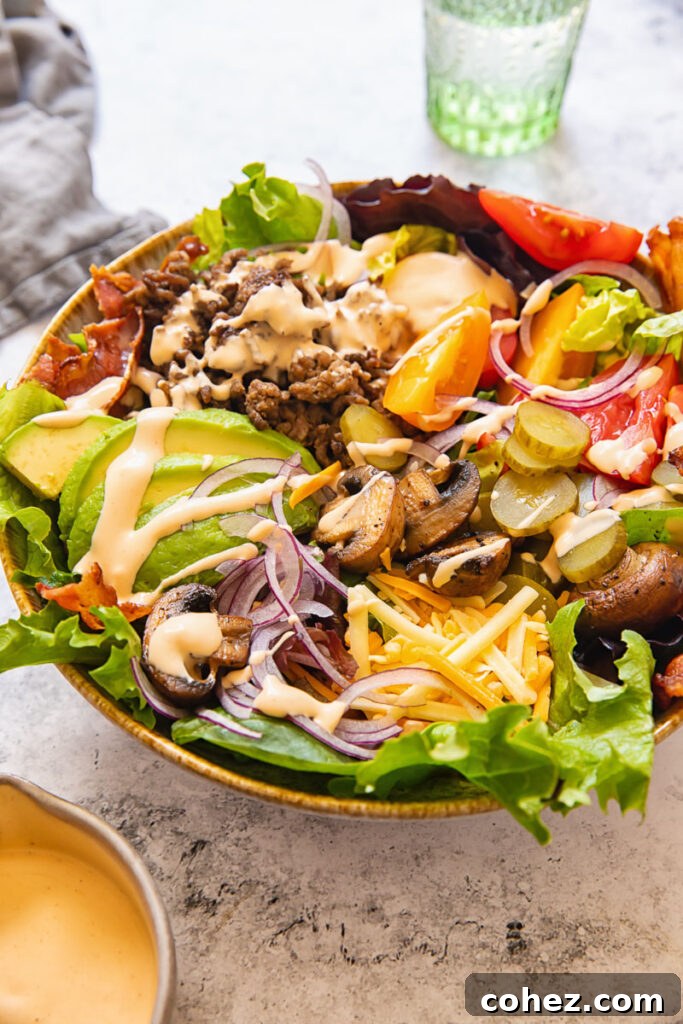 Flavor-Packed Burger Bowl 4 Side view of a loaded burger in a bowl, showcasing layers of ingredients