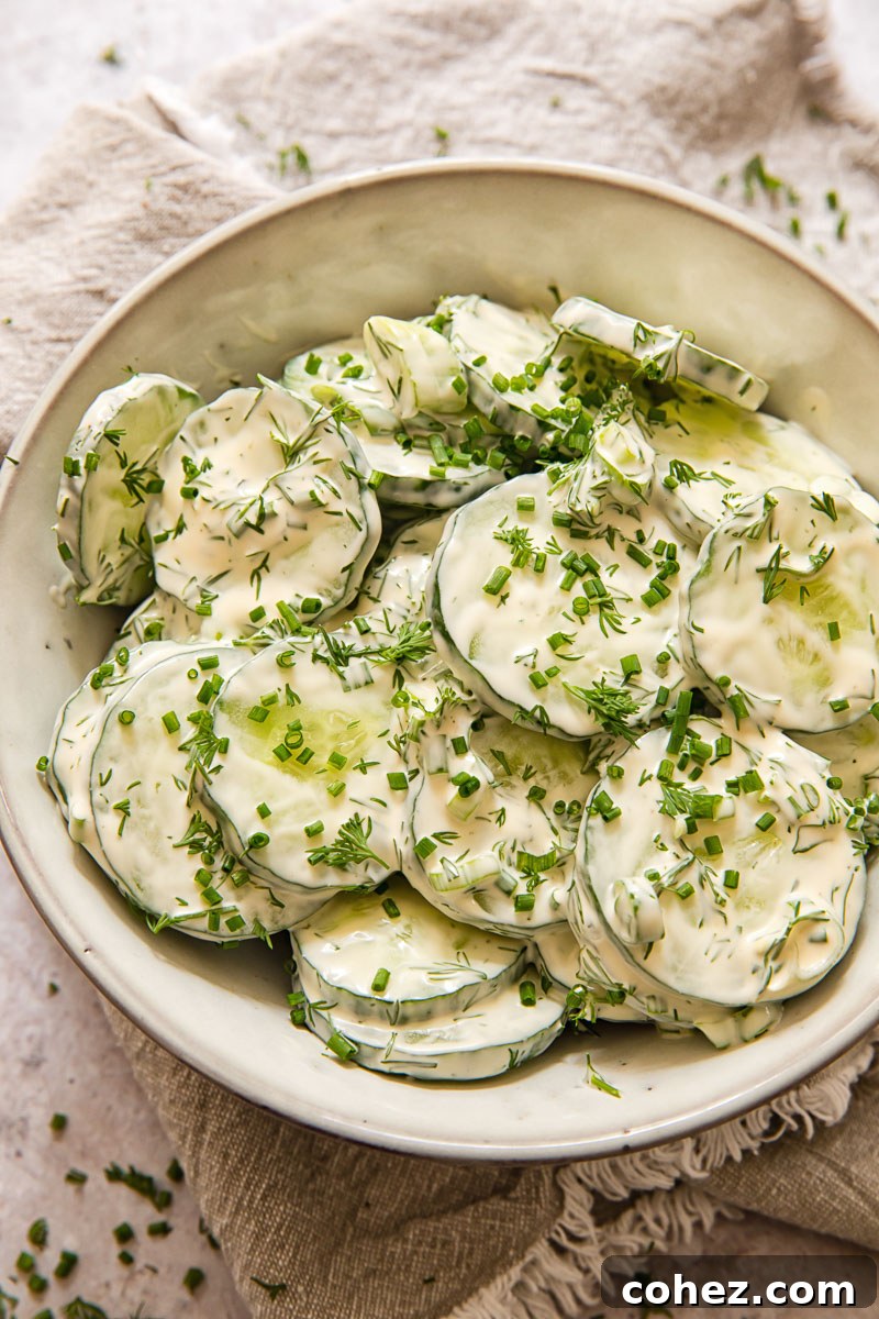 A top-down view of creamy cucumber salad in a stylish grey bowl, ready to be served.