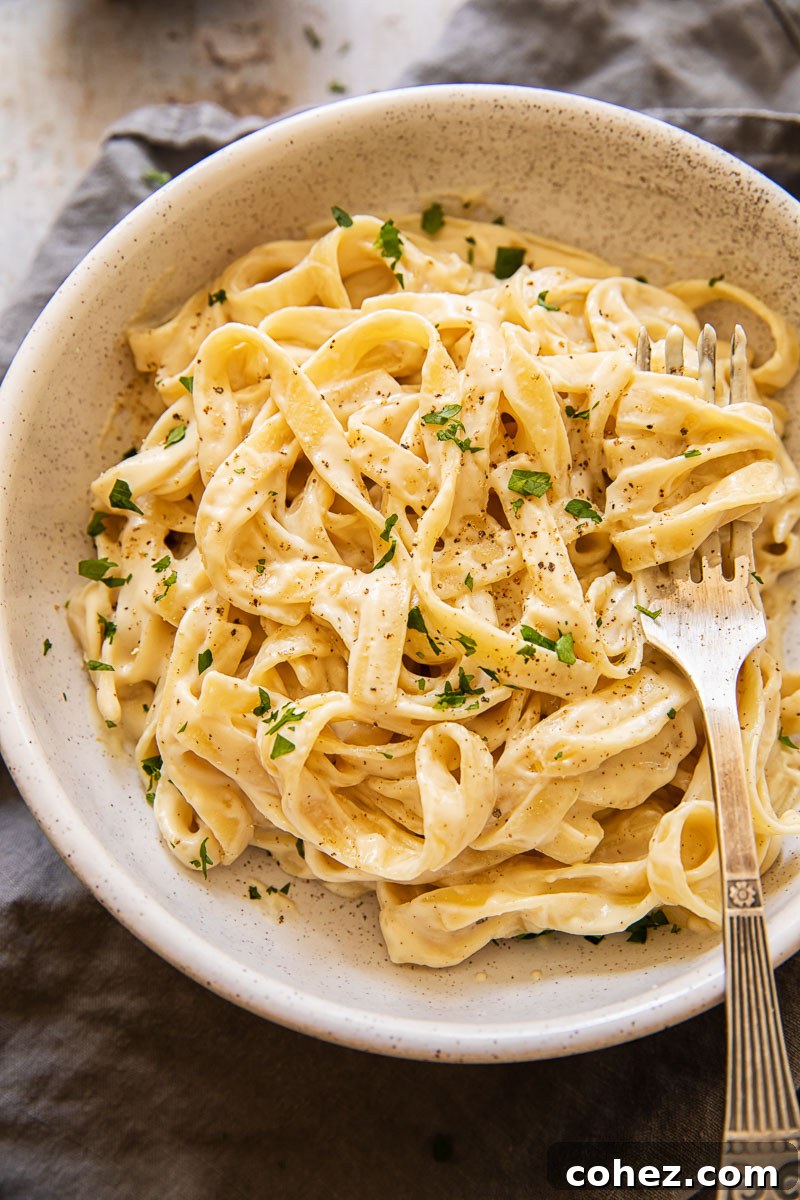 Fettuccine Alfredo in a bowl sprinkled with fresh parsley