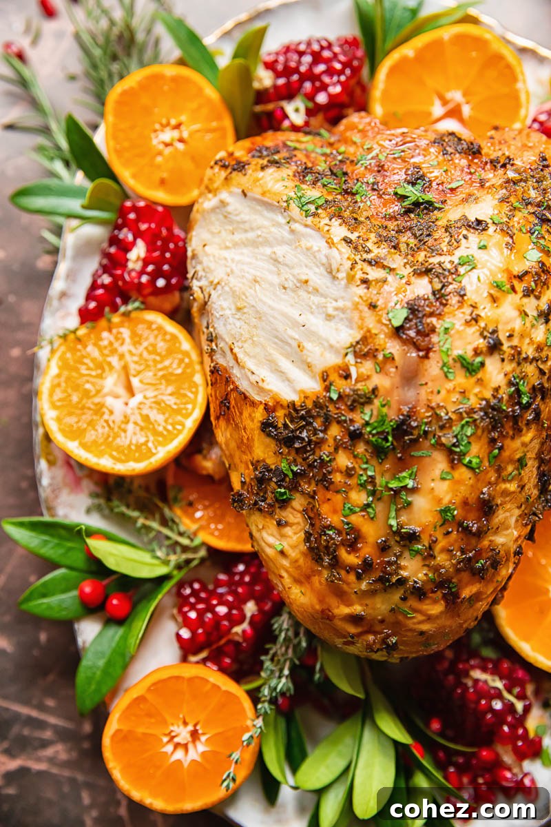 top down view of roast turkey breast garnished with sliced oranges and pomegranates