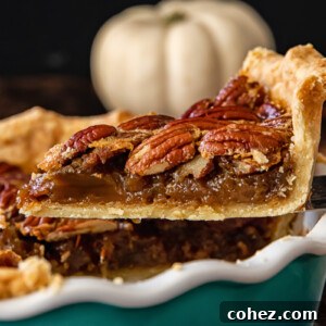 A beautiful slice of Maple Bourbon Pecan Pie, featuring a crisp crust and a rich, gooey filling, ready to be enjoyed.