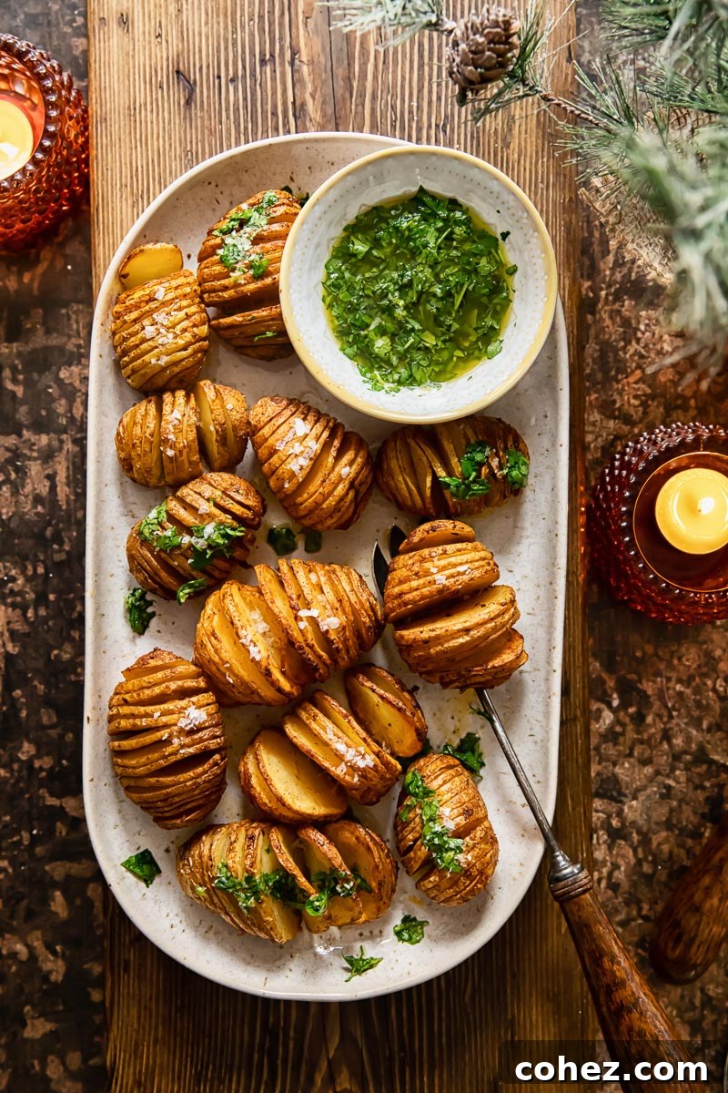 Platter of perfectly roasted hasselback potatoes on a wooden serving board, ready for a festive dinner