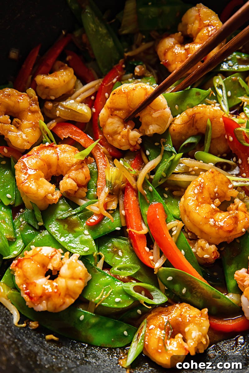 close up of prawn and vegetable stir fry in a wok