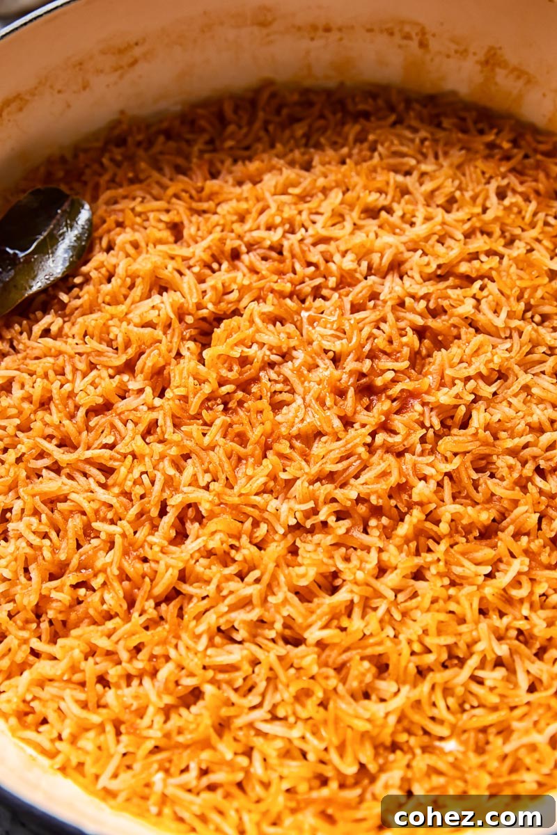 Vibrant orange Peri Peri rice simmering in a pan, ready to be served