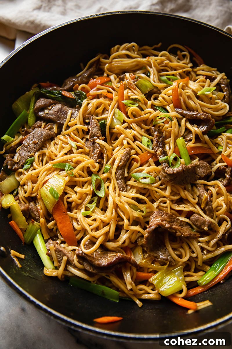 top down view of beef chow mein in a wok