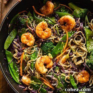 top down view of prawn noodle stir fry in a wok