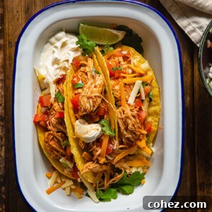 Fiesta Ready Instant Pot Chicken Tacos 6 Top down view of delicious Instant Pot shredded chicken tacos arranged in a white dish