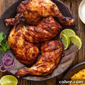 Top down view of tandoori chicken legs on a brown platter