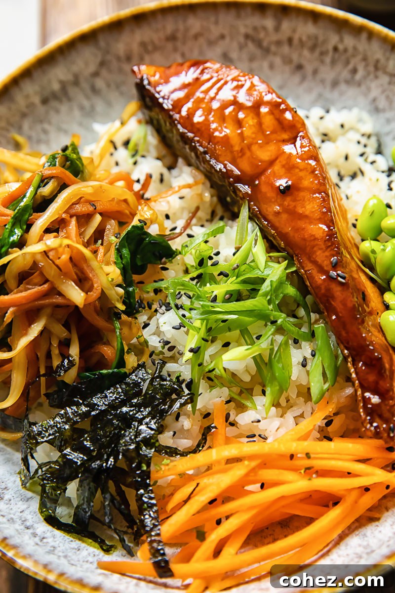 Savory Teriyaki Salmon Donburi 5 A beautifully presented teriyaki salmon donburi bowl, close-up, featuring the glistening salmon, stir-fried vegetables, and various toppings for maximum visual appeal.