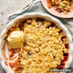 Top-down view of rhubarb crumble with vanilla ice cream in a pan and on a pink plate