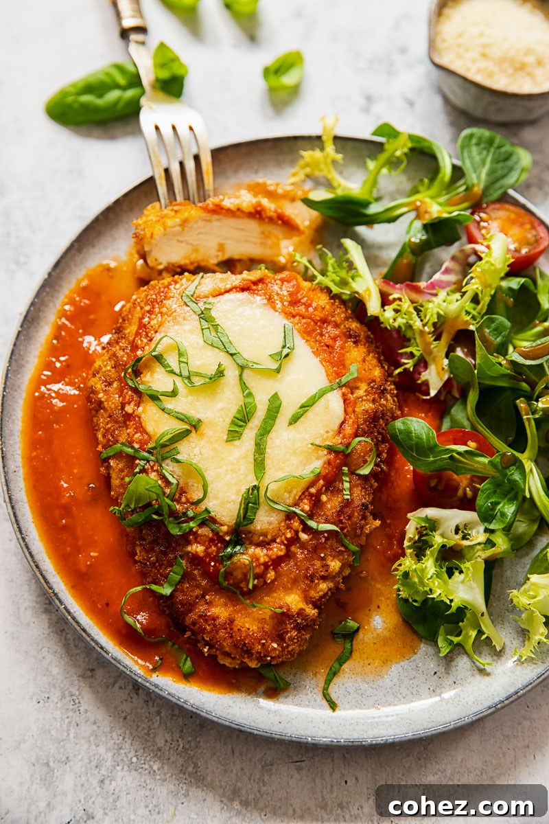 chicken parmesan on a plate with salad