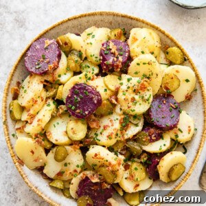 Top-down view of potato salad with white and purple potatoes