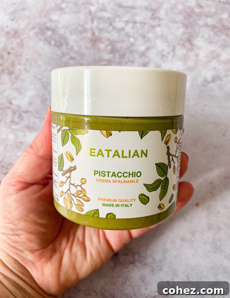 A jar of rich pistachio crema, highlighting its vibrant green color and smooth texture.
