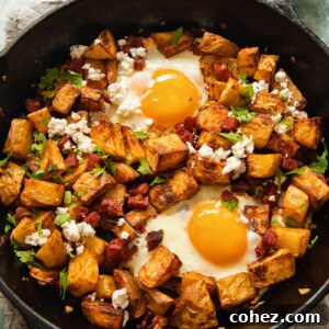 Spicy Chorizo Hash with Feta 6 top down view of a skillet with diced potatoes, chorizo and egg with feta