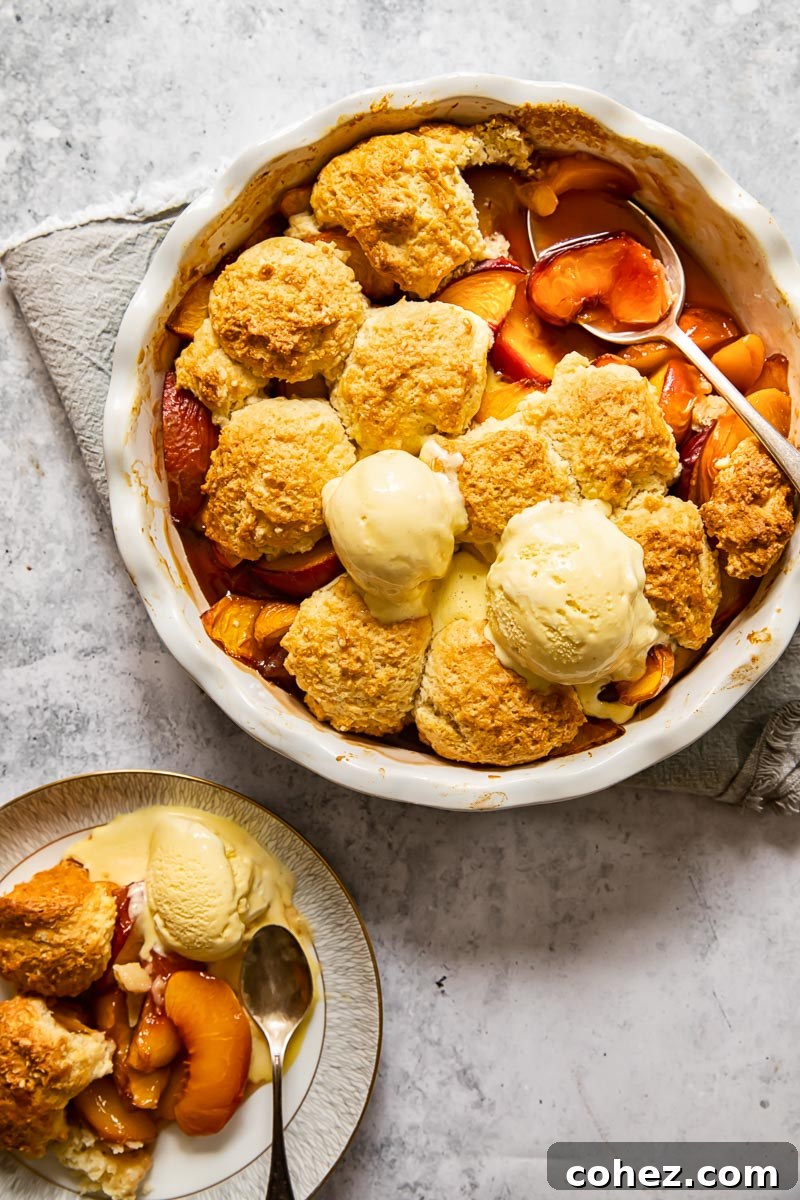 Golden Maple Peach Cobbler 5 top down view of peach cobbler topped with two ice cream scoops
