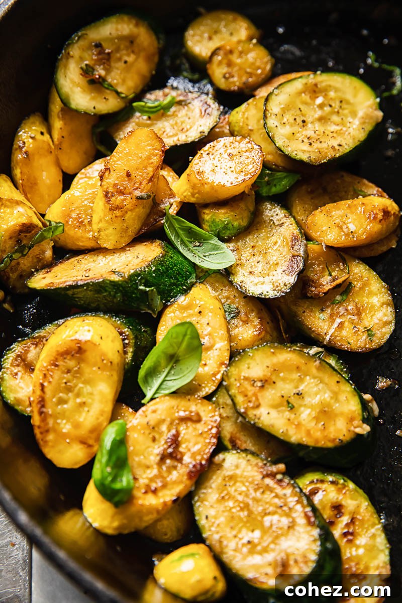 Crispy Zucchini with Aromatic Basil and Pecorino 5 Close-up of perfectly browned and seasoned pan-fried zucchini, showcasing its tender texture and delicious caramelization from a hot pan.