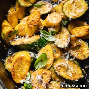 Close up of golden brown pan-fried zucchini, garnished with fresh basil