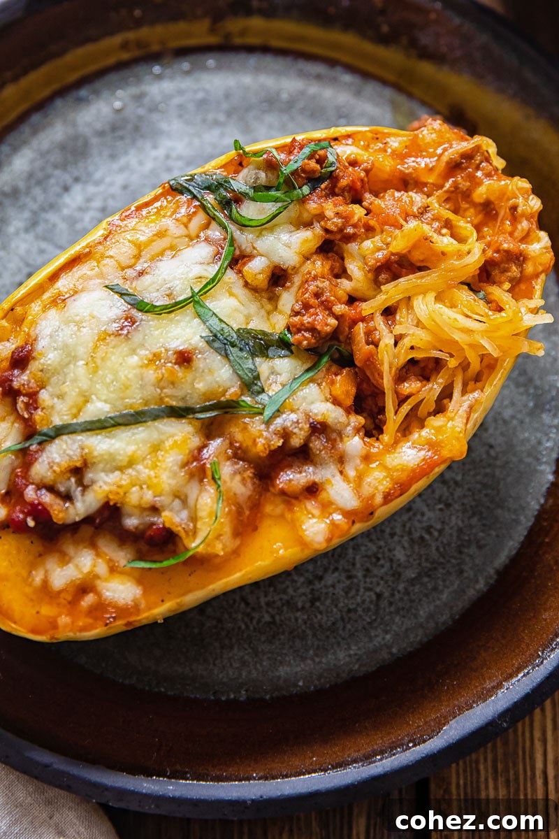 Close-up of roasted spaghetti squash on a plate, with its characteristic spaghetti-like strands visible and ready to be enjoyed.