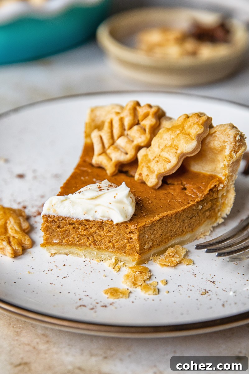 a slice of pumpkin pie on a plate with a bite taken out