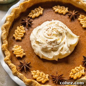 top down view of pumpkin pie topped with whipped cream in the middle