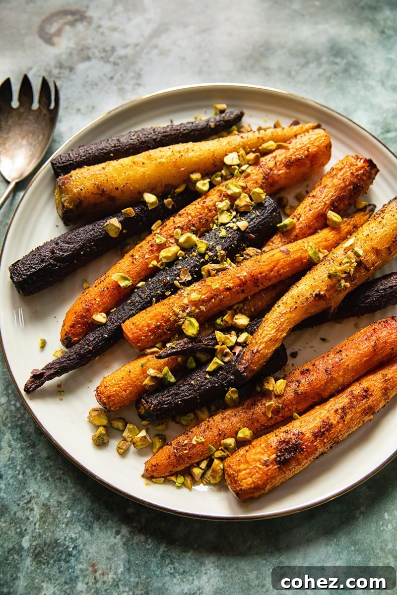 Vibrant Roasted Carrots with Pistachio Crunch 4 top down view of cooked carrots with pistachios on a white platter